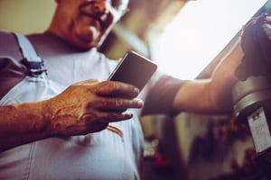 worker on smartphone in manuf