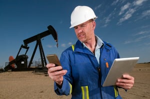 A oil and gas industry worker leverages digital technology out in the field.