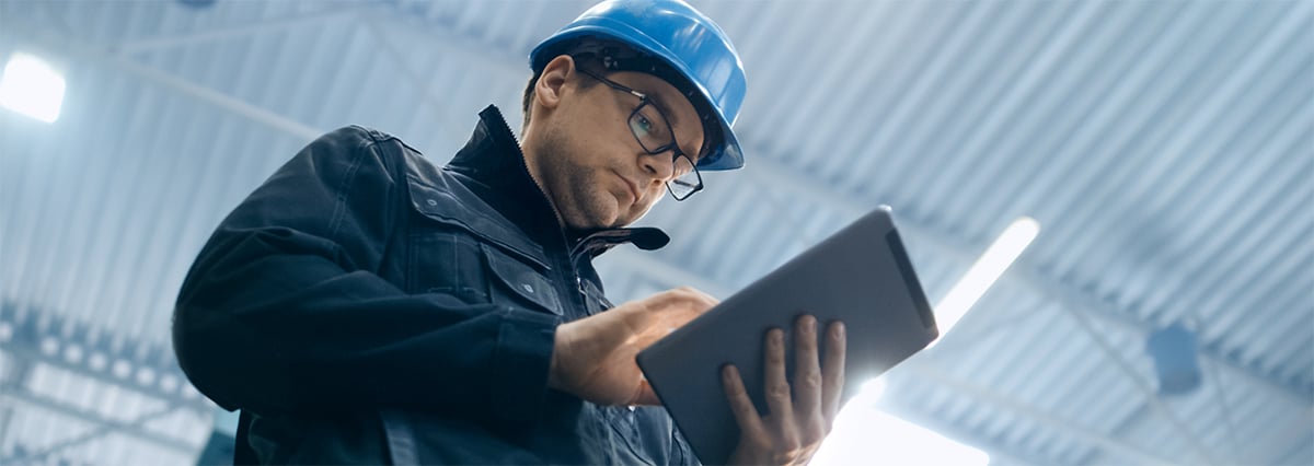 Manufacturer reviewing data on a tablet