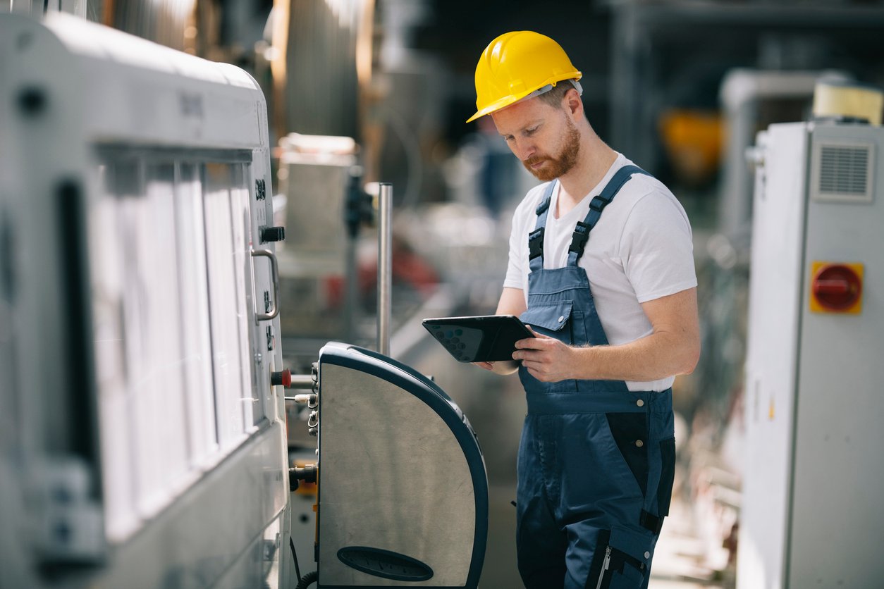 Quality inspector reviewing production output on a manufacturing floor