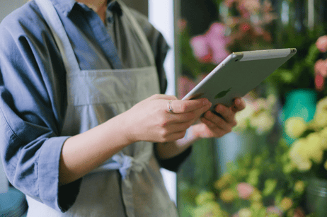 Restaurant staff member using a digital tablet.