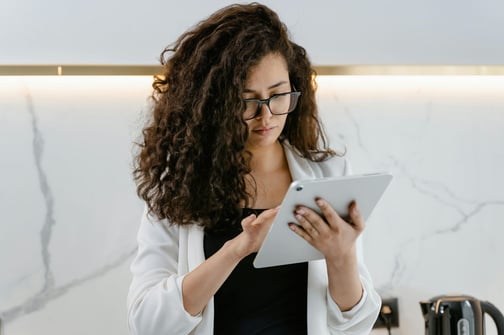 Researcher using a tablet to collect field data with digital forms.