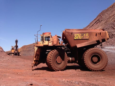 Heavy mining equipment operating at a mine site.