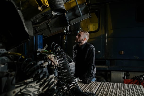 Mining maintenance technician inspecting heavy equipment.