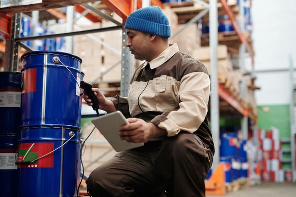 Environmental technician scanning a barcode label on a sample container with a mobile device