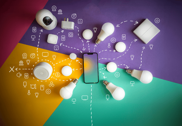 Smartphone surrounded by smart home devices and icons on a colorful geometric background with connecting lines.