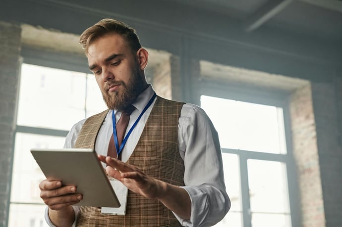 Manufacturing supervisor using a mobile device to digitize a paper inspection form.