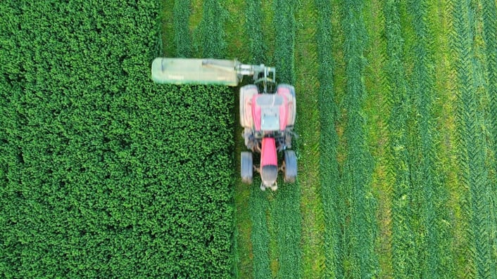 Aerial view of a tractor in a farm, representing a modern farming operation.