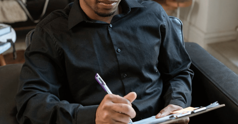 Operator filling out a scrap report form.