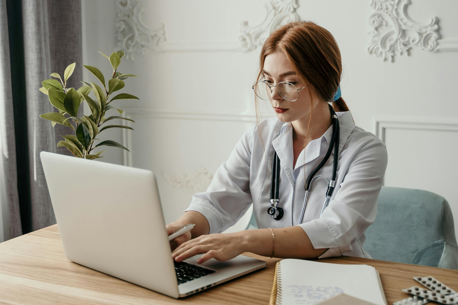 Female doctor working on a laptop in a medical office