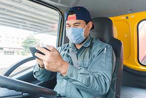 Worker in mask on mobile