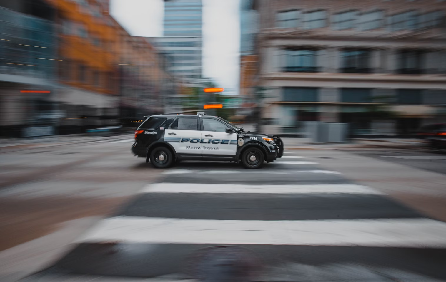 Black and white police car on the road during daytime.